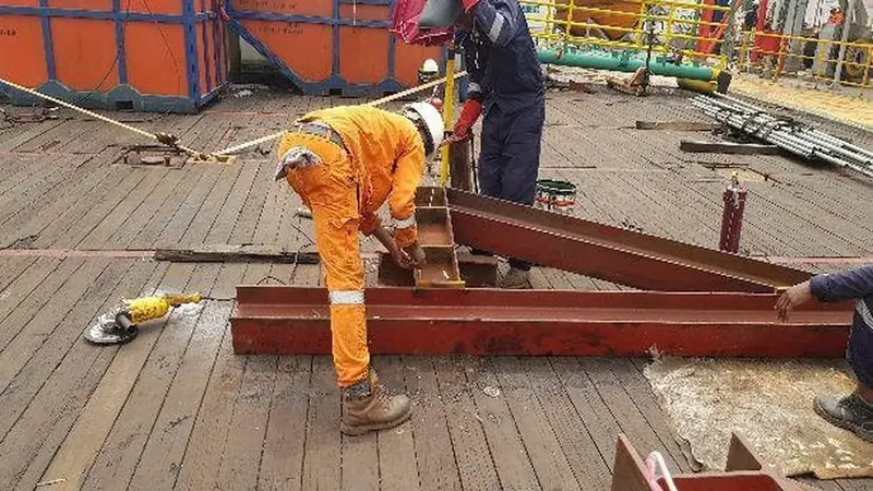 Structural steel plate being cut and welded during barge deck fabrication